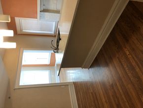 St. Louis apartment for rent - the view from the bottom of the stairs looking down into the living room and hallway