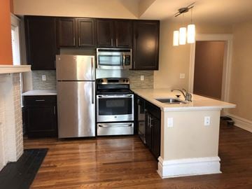 St. Louis apartment for rent - a kitchen with stainless steel appliances and black cabinets
