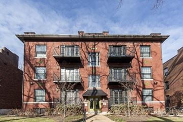 Saint Louis apartment for rent - a red brick building with black windows and a sidewalk