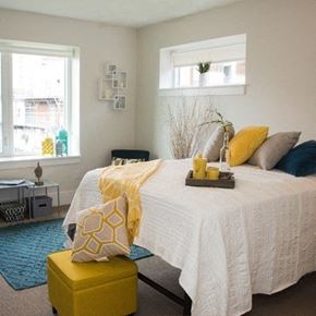 St. Louis apartment for rent - A bedroom with a bed, nightstand, and window.