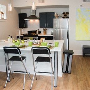 St. Louis apartment for rent - A kitchen with a white table and black chairs.