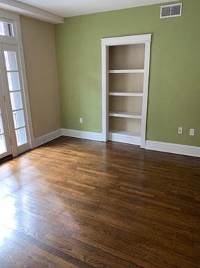 Saint Louis apartment for rent - a living room with a wood floor and a book shelf