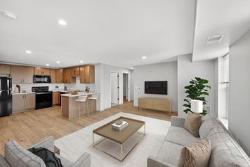 Minneapolis apartment for rent - A modern living room with a grey sofa and a coffee table.