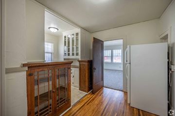 St Paul apartment for rent - A white refrigerator is in a kitchen with wood floors and cabinets.