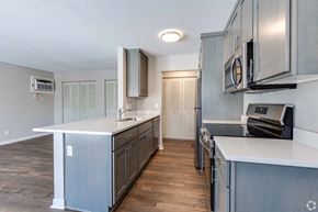 North St. Paul apartment for rent - A kitchen with a white counter top and wooden floors.