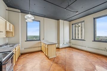 St. Paul apartment for rent - A kitchen with a stove top oven and a window.