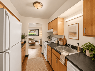 St. Paul apartment for rent - A kitchen with a white refrigerator and wooden cabinets.