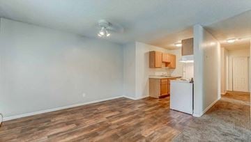 Oakdale apartment for rent - A kitchen area with a white refrigerator and wooden flooring.