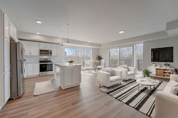 Minneapolis apartment for rent - a white living room with a kitchen and a rug