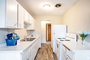 St. Paul apartment for rent - A kitchen with white appliances and cabinets.