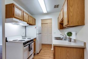 Oakdale apartment for rent - A kitchen with white appliances and wooden cabinets.