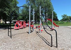 Maplewood apartment for rent - A playground with a red slide and a black metal structure.