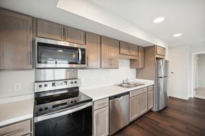 Cambridge apartment for rent - a kitchen with stainless steel appliances and wooden cabinets