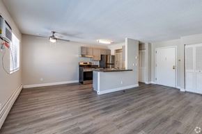 North St. Paul apartment for rent - A spacious kitchen with a bar area and a ceiling fan.