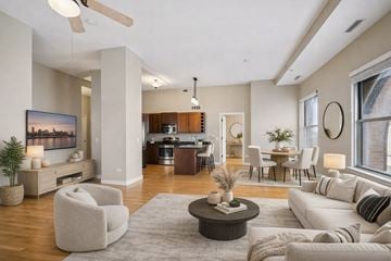 St Paul apartment for rent - A modern living room with a large painting on the wall and a ceiling fan.