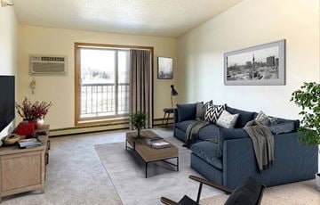 Coon Rapids apartment for rent - A living room with a blue couch and a television.