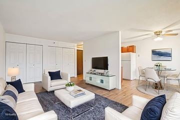 St. Paul apartment for rent - A living room with white furniture and a flat screen TV.