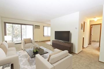 St. Anthony apartment for rent - a living room with white furniture and a television