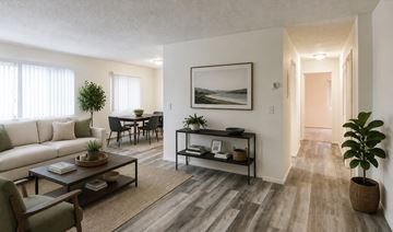 St Paul apartment for rent - A living room with a white couch, a coffee table, and a painting on the wall.