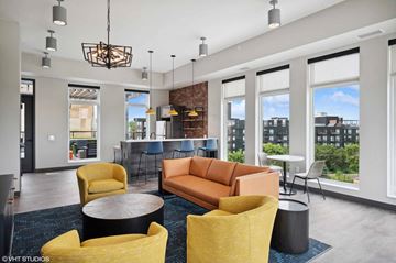 Minneapolis apartment for rent - a living room with a couch and chairs in front of large windows