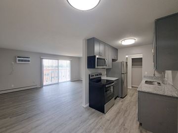 Richfield apartment for rent - A kitchen with a stove top oven and microwave above the stove.