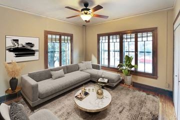 St. Paul apartment for rent - a living room with a gray couch and a ceiling fan