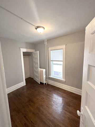 Minneapolis apartment for rent - a living room with a wooden floor and a window and a white closet
