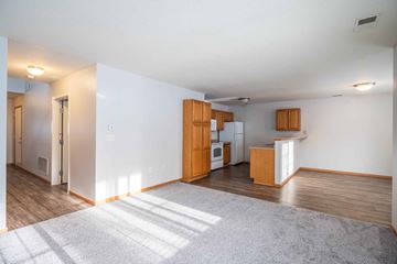 Jordan townhouse for rent - A kitchen area with wooden cabinets and a refrigerator.