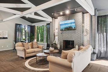 Clinton Township apartment for rent - A living room with a fireplace and a painting on the wall.