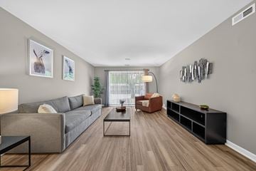 Clinton Township apartment for rent - Spacious living room with Sliding Glass Door at Lakeside Village Apartments in Clinton Township, MI.