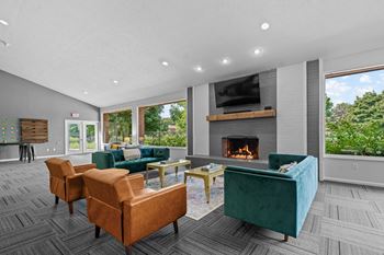 Spacious community clubhouse with lounge and kitchen at dover hills apartments in kalamazoo, mi.