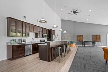 Spacious community clubhouse with lounge and kitchen at dover hills apartments in kalamazoo, mi.