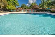 Westland apartment for rent - Heated pool equipped with comfy lounge chairs at Westwood Village Apartments in Westland, MI