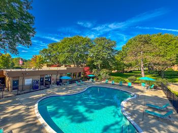 Two heated pools with sundecks at westwood village apartments in westland, mi.