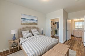 Rio Rancho apartment for rent - A bedroom with a large bed and a painting on the wall.