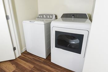In unit washer and dryer with wood style flooring