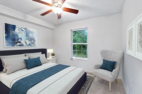 Vero Beach apartment for rent - a bedroom with a bed and a ceiling fan
