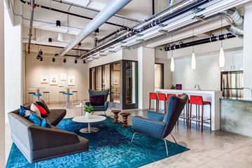 Minneapolis apartment for rent - a living room with couches and chairs and a bar in a loft