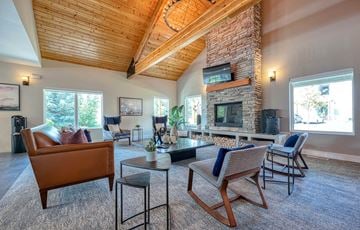 Hailey apartment for rent - a living room with a large stone fireplace and furniture
