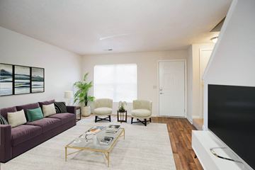 Murfreesboro apartment for rent - a living room with a purple couch and a tv