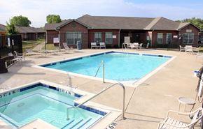 Fort Worth apartment for rent - A swimming pool with a blue tiled edge and a white ladder.
