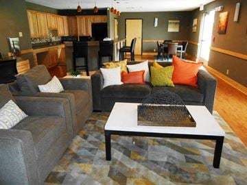 Orange apartment for rent - a living room with couches and a coffee table