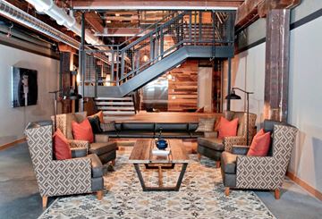 Minneapolis apartment for rent - a living room with couches and chairs and a staircase