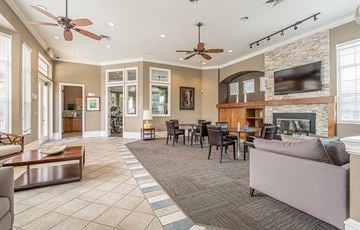 Orlando apartment for rent - a living room with a fireplace and a table with chairs