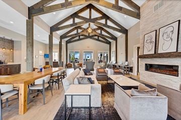 Nashville apartment for rent - a large living room with couches and tables and a fireplace