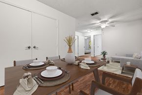 Port Richey apartment for rent - a dining room with a table and chairs and a ceiling fan