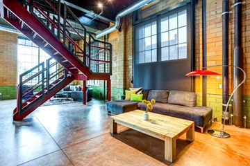 St. Paul apartment for rent - a living room with a staircase and a couch and a coffee table