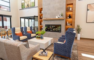 Mesa apartment for rent - a living room with blue chairs and a fireplace