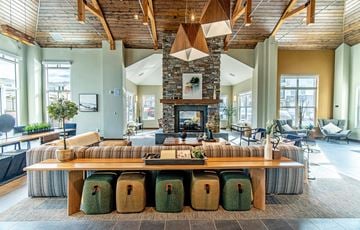 Parker apartment for rent - a large living room with a fireplace and a large table