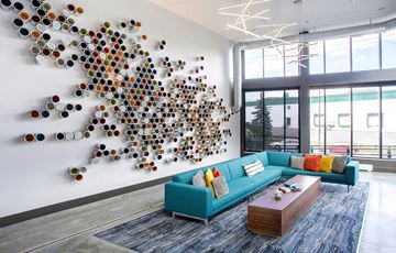 St. Paul apartment for rent - a living room with a blue couch and a wall with spheres on it